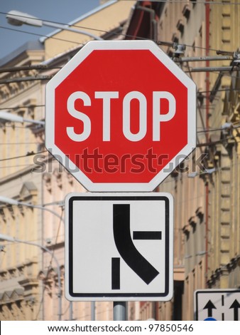 Stop - traffic sign at a dangerous crossroad