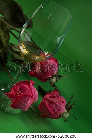 Wine and roses Wine in the broken glass and dry roses