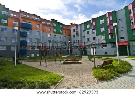 Ideal council estate, houses everyone would like to live in, with playground for kids, colorful, blue sky