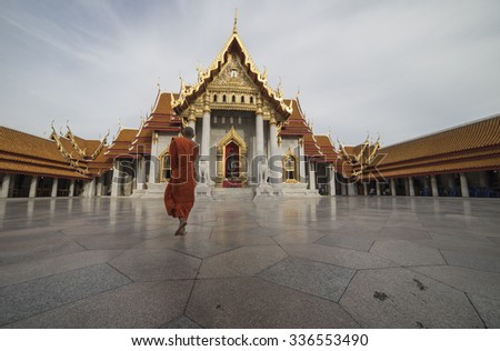 Priest walking in Wat Benchamabophit Dusitvanaram, is a Buddhist temple in the Dusit district of Bangkok, Thailand.
