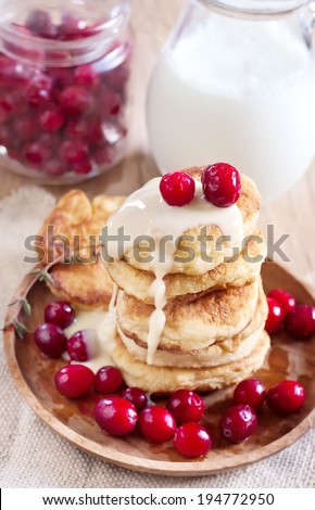 Russian quark pancakes with condensed milk and cranberry. Selective focus.