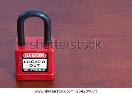 Lockout Padlock red color on wood background