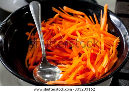 Slice carrot in black bowl,selective focus