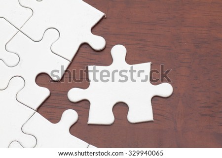 Missing jigsaw puzzle piece, business concept for completing the final puzzle piece on wood