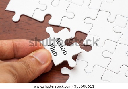 Placing missing a piece of puzzle with action plan word