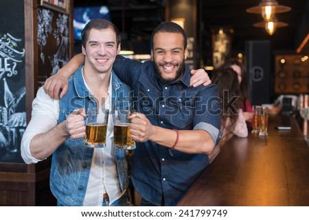 Beer in a pub is fun Portrait of two handsome friends in a pub w