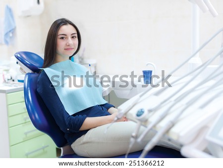 The perfect smile and perfect teeth. The patient dentist sitting in the dental chair waiting for professional consultancy of doctor