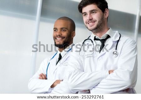 Doctors at work. Portrait of two doctors colleagues who are standing in the hospital in a white coats and thinking about their patientsÃ?Â¢?? health
