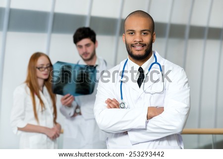 Portrait of a doctor of the therapist. Confident doctor is standing in the hospital in a white coat and thinking about patient and health