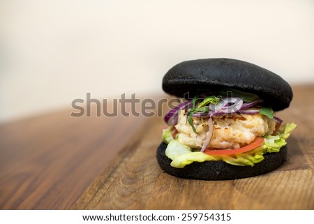 Classic Burger. Tasty and fastfood black burger meal on the table