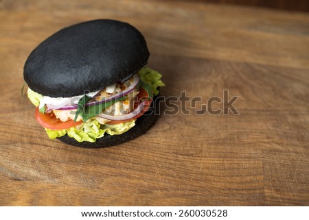 Classic black Burger. Tasty and fastfood burger meal on the table