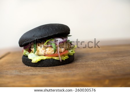 Classic black Burger. Tasty and fastfood burger meal on the table
