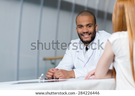 Doctor at work in a hospital. Portrait of confident and professional doctor therapist wearing white medical clothes with his patient. Medical concept. Stethoscope
