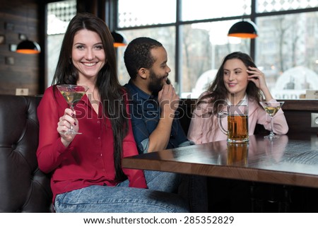 Perfect beer party. Portrait of beautiful girl in a pub. Girls is holding alcohol cocktail and having fun with her friends. Beer pub concept
