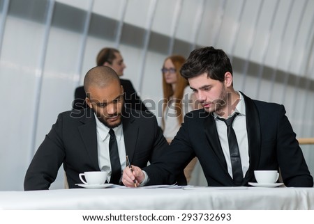 Excellent business cooperation . Two young motivated successful business partners are on the business meeting. Business meeting concept. African businessman