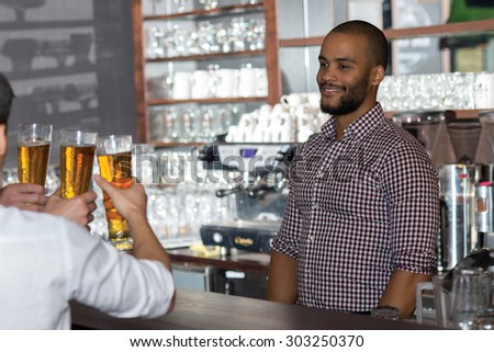Beer evening in a pub. Portrait of barman and guy drinking beer in a pub. Beer glasses.  Beer pub concept