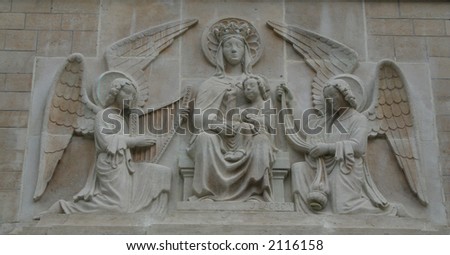 Nativity. Stone relief of Mary with the infant Jesus guarded by two angels.