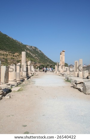 Tour party leaves a colonnaded road in the ruins of Ephasus on a blazing hot summers day.
