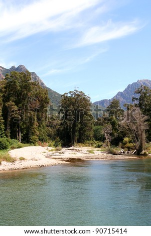 Flowing river in the heart of Corsica. Trees line the riverbank.