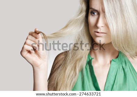woman holding ends of her hair