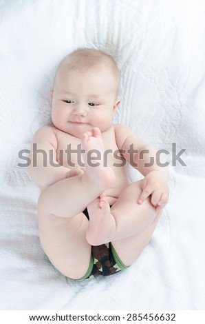 Baby plays with his feet