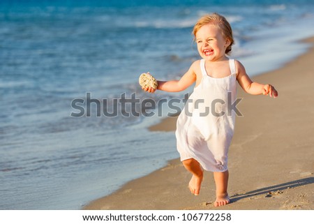 Little girl running on the beach