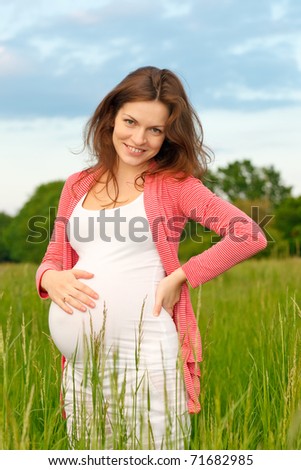 Outdoor portrait of beautiful pregnant woman