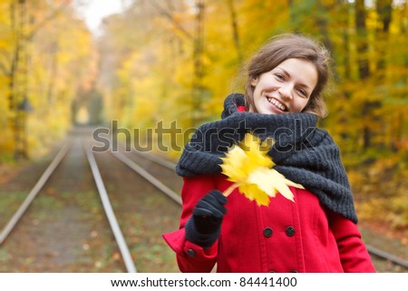 Smiling woman in autumn park