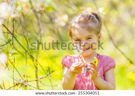 Happy little girl playing in sunny park