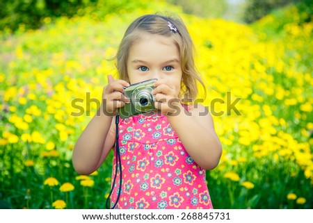 Little girl taking pictures with point and shoot camera
