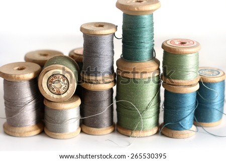 Spools of thread on a white background. Old sewing accessories. colored threads