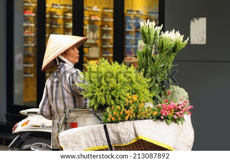 HANOI, VIETNAM - AUGUST 21: Unidentified flower vendor at the flower small market on April 21, 2014 in Hanoi, Vietnam. This is a small market for retail florists and street vendors.