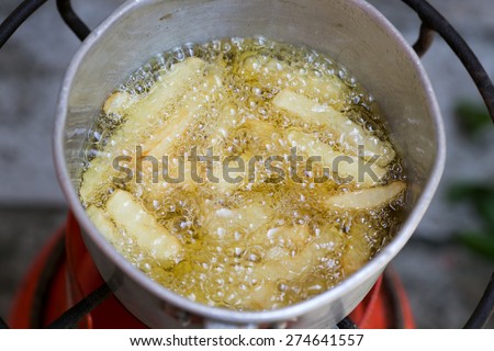 Fried Potato Chips Boiling In Hot Oil,Preparing French Fries In Hot Boiling Oil With Fresh Potato Chips