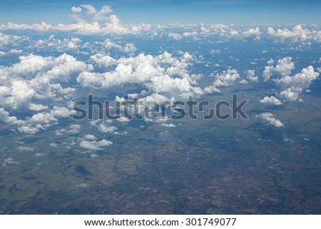 Sky clouds and land background. Top view of the plane