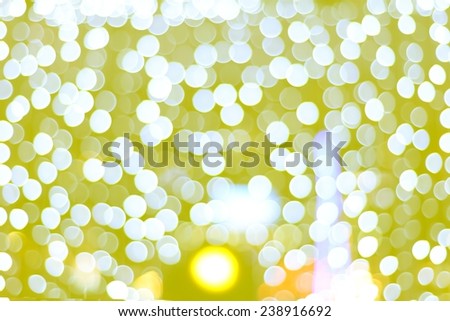 defocused christmas lights on soft yellow colors tone