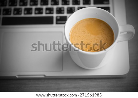 Hot latte coffee cup and laptop on Black and White background