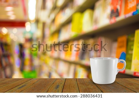 Blur image of coffee and book store on shelf at shopping center for background usage.