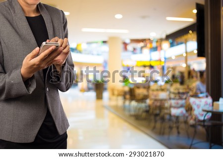 Women in Coffee shop using mobile phone