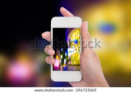 Women hand holding blank mobile smart phone and City night light blur bokeh background.