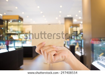 Photo blank. Hand hold blank business card in the shopping mall.
