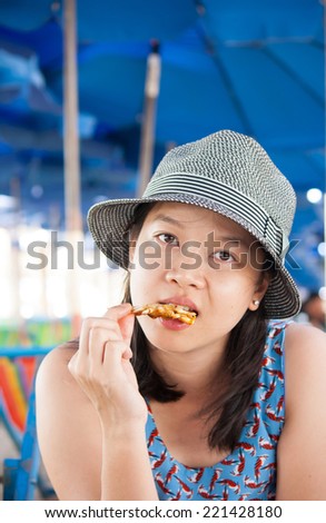 Woman eating seafood outside in summer smiling happy at camera. Asian Caucasian girl eating healthy fresh seafood.