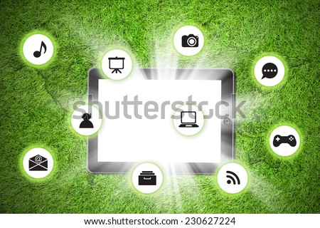 Tablet pc on with icon on grass background