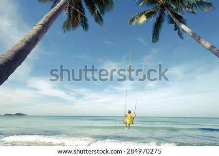 Boy swing in the sea -  vintage effect style