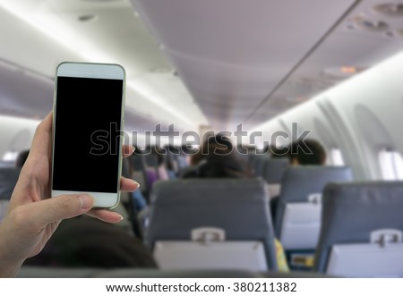 Man use your phone in airplane blurred background - mockup template