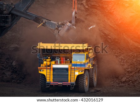 Big mining truck unload coal in coal mining, mining process