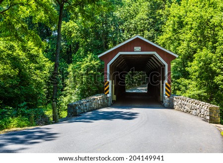 Red covered bridge during summer in Lancaster County Pennsylvania