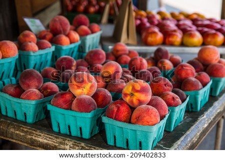 Group of peaches in boxes at country roadside stand in rural Pennsylvania.