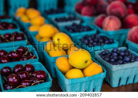 Rows of various fruits in boxes at country roadside stand in rural Pennsylvania.
