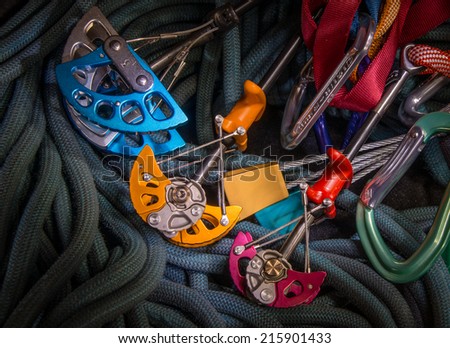 Colorful climbing gear including ropes and chocks.