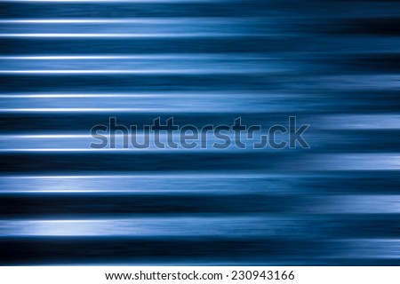 Light blue corrugated metallic background with blur filter applied.